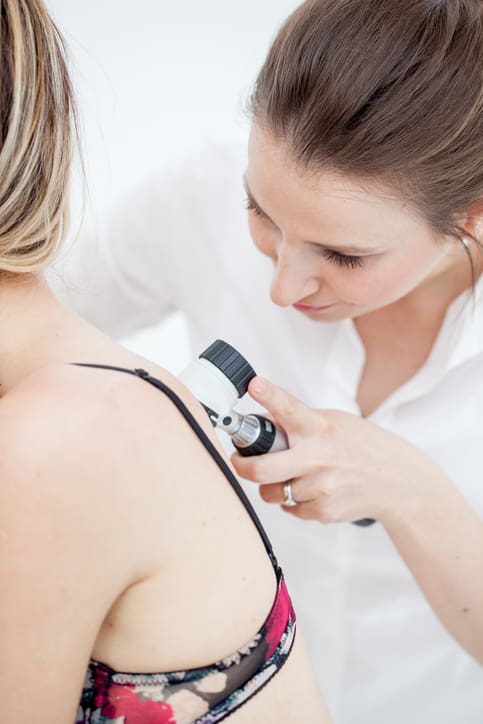 Dermatologist Inspecting Patient Skin Moles with Dermatoscope Full Body Skin Exam in New York, NY